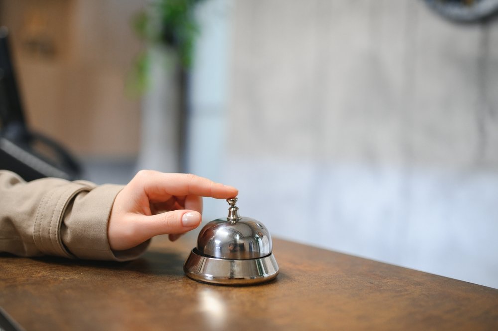 Hand,Of,A,Woman,Using,A,Hotel,Bell.