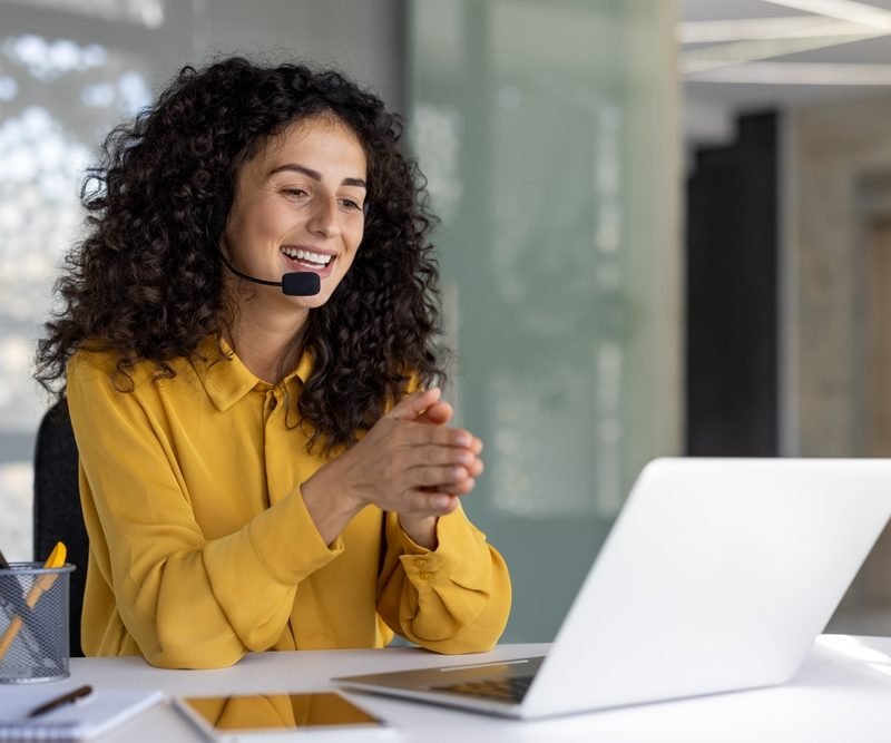 A,Cheerful,Customer,Service,Representative,Wearing,A,Headset,Smiles,While